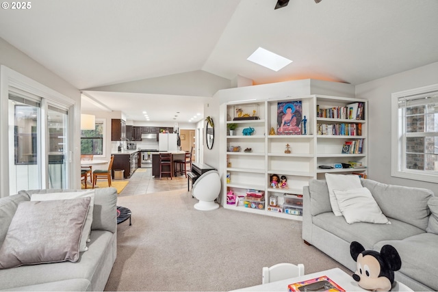 living area with light colored carpet, vaulted ceiling, and light tile patterned floors