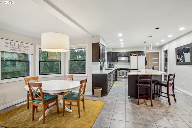 tiled dining area featuring sink