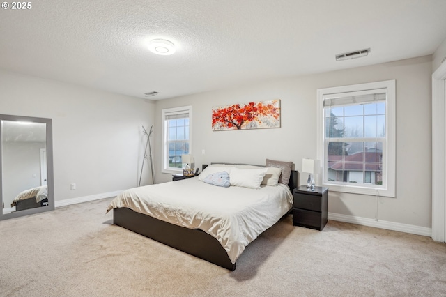 carpeted bedroom with a textured ceiling