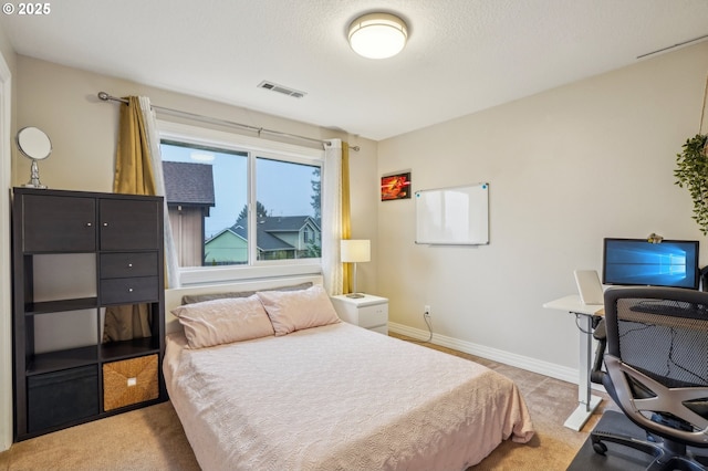 bedroom featuring a textured ceiling, light colored carpet, visible vents, and baseboards