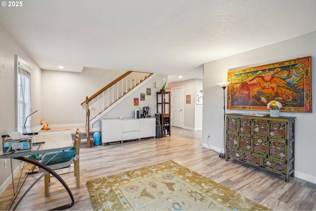 interior space with a textured ceiling and hardwood / wood-style flooring