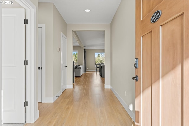 hall with light wood-type flooring, baseboards, and recessed lighting