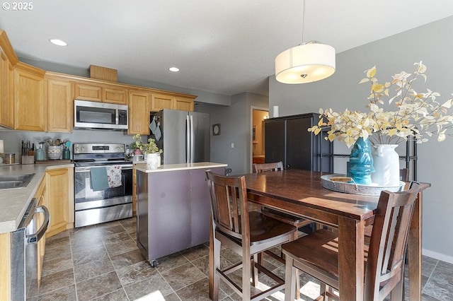 kitchen featuring recessed lighting, appliances with stainless steel finishes, light brown cabinetry, and light countertops