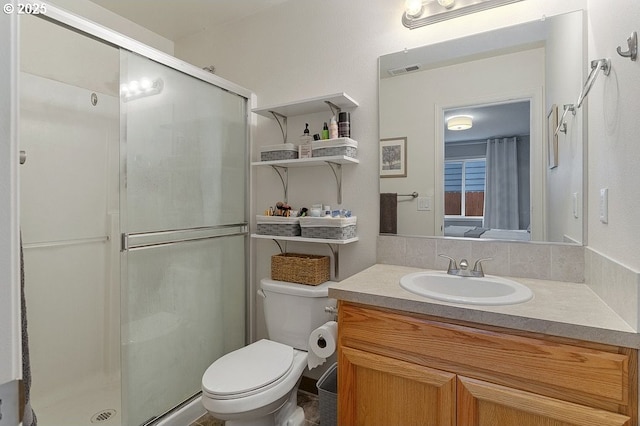 full bath featuring visible vents, toilet, a stall shower, and vanity