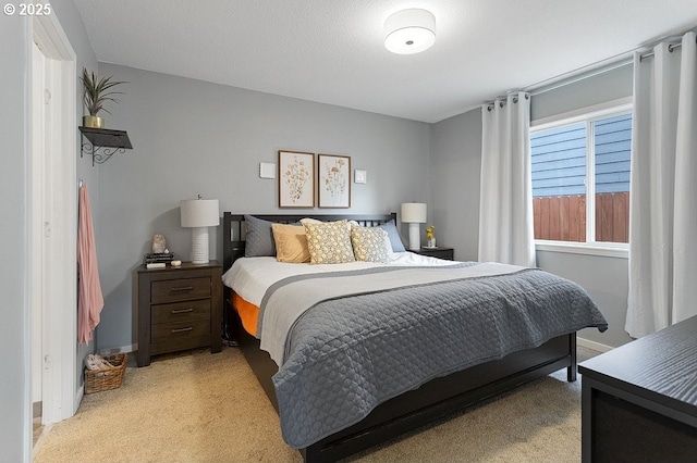 bedroom with light carpet and baseboards