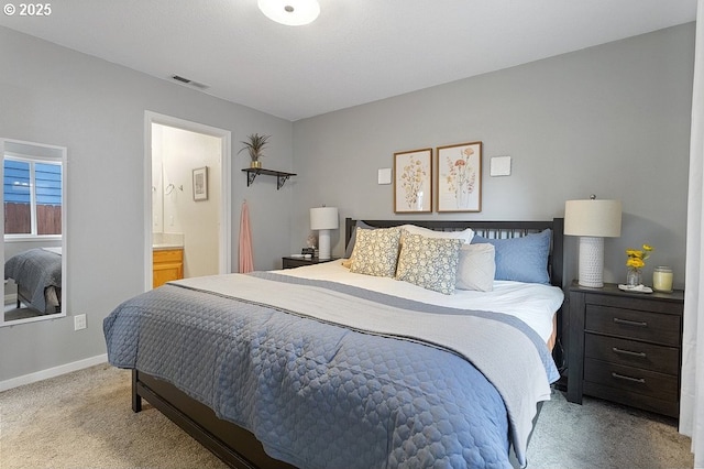 bedroom featuring visible vents, baseboards, connected bathroom, and carpet flooring