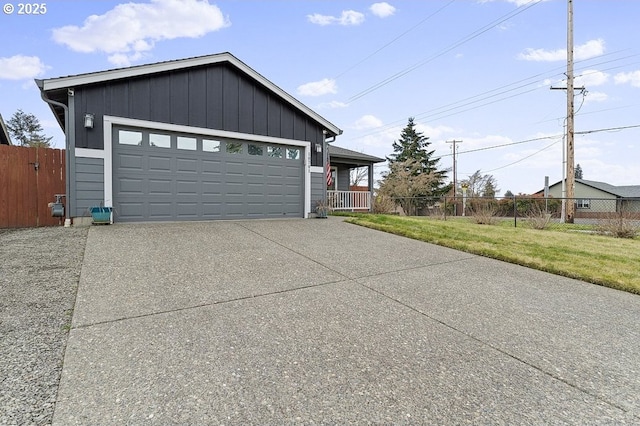 view of front of property with a garage, a front lawn, and fence