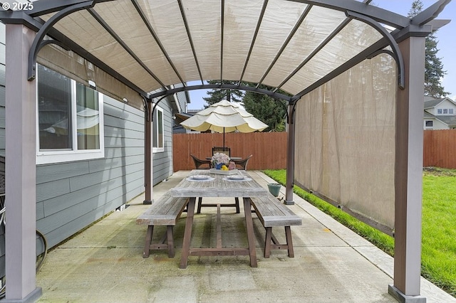 view of patio with outdoor dining space, fence, and a pergola