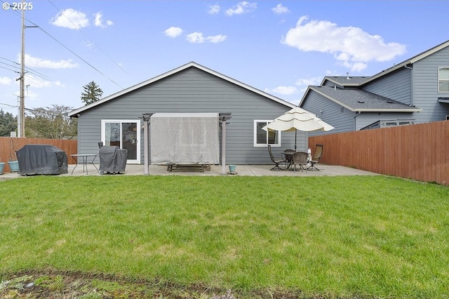 rear view of house with a yard, a patio area, and fence