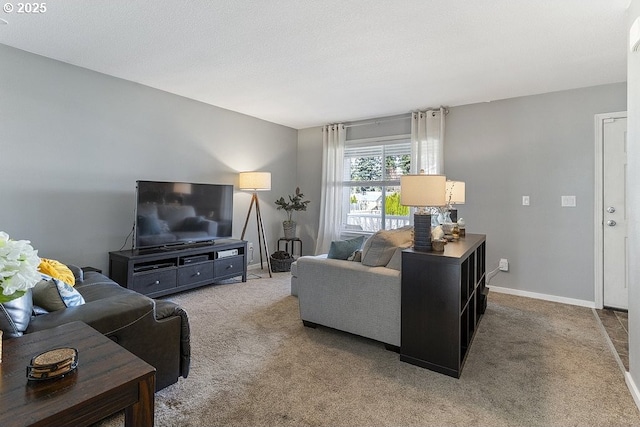 living room featuring carpet flooring, a textured ceiling, and baseboards