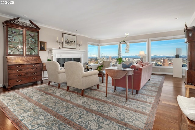 living room featuring a wealth of natural light, wood-type flooring, and ornamental molding