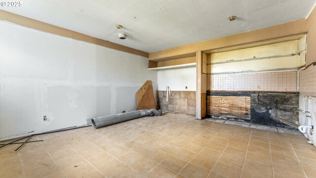 unfurnished living room featuring a textured ceiling