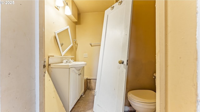 bathroom featuring vanity, toilet, and tile patterned floors