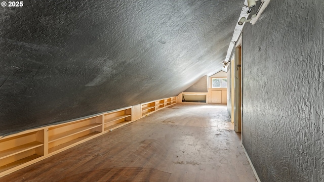 bonus room featuring vaulted ceiling and a textured ceiling