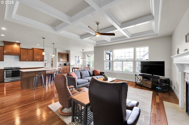 323 Argon Ave, Eugene, OR 97404 - living room with ceiling fan, light wood-style floors, a premium fireplace, coffered ceiling, and beam ceiling
