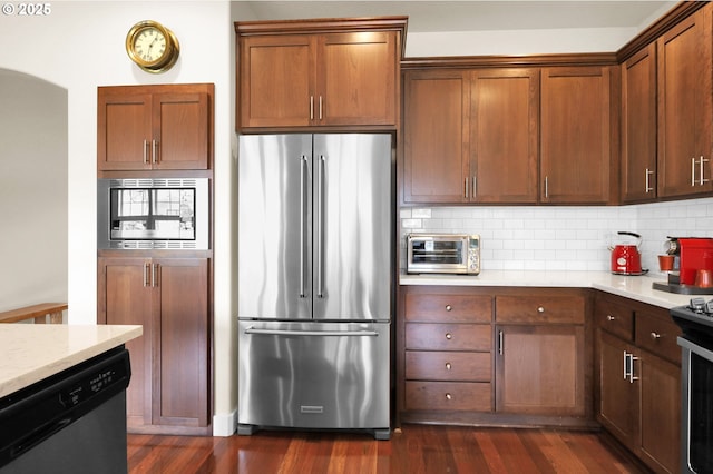 323 Argon Ave, Eugene, OR 97404 - kitchen featuring appliances with stainless steel finishes, backsplash, dark wood finished floors, and arched walkways