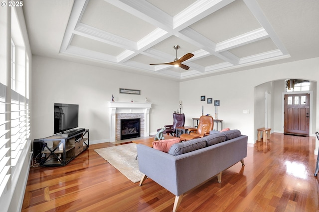 323 Argon Ave, Eugene, OR 97404 - living area with arched walkways, a fireplace, wood finished floors, coffered ceiling, and ceiling fan