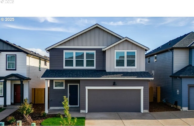 2878 U St, Springfield, OR 97477 - view of front facade featuring board and batten siding, concrete driveway, an attached garage, and a shingled roof