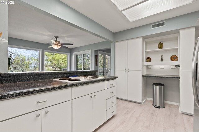 48 Eagle Crest Dr Unit 2E, Lake Oswego, OR 97035 - kitchen with light wood-style flooring, white electric stovetop, visible vents, white cabinetry, and open shelves