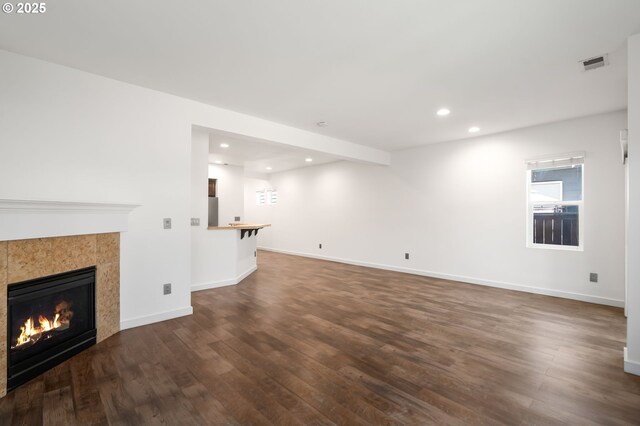 4077 SE Lone Oak St, Hillsboro, OR 97123 - living area featuring wood finished floors, a tiled fireplace, and baseboards