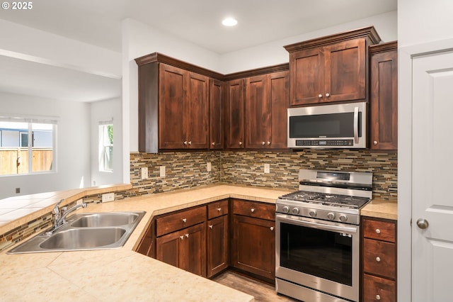 4077 SE Lone Oak St, Hillsboro, OR 97123 - kitchen with appliances with stainless steel finishes, a sink, light countertops, decorative backsplash, and recessed lighting