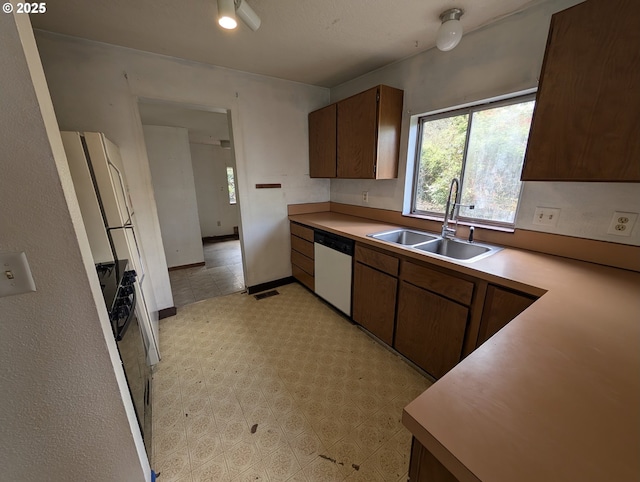 10539 NW 3rd St, Portland, OR 97231 - kitchen featuring white dishwasher, a sink, light countertops, and refrigerator