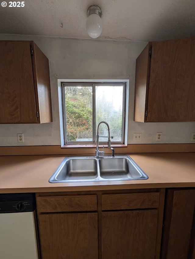 10539 NW 3rd St, Portland, OR 97231 - kitchen with white dishwasher, a sink, and light countertops