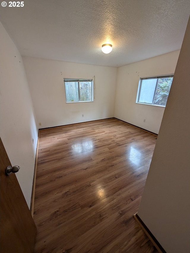 10539 NW 3rd St, Portland, OR 97231 - unfurnished room with wood finished floors and a textured ceiling