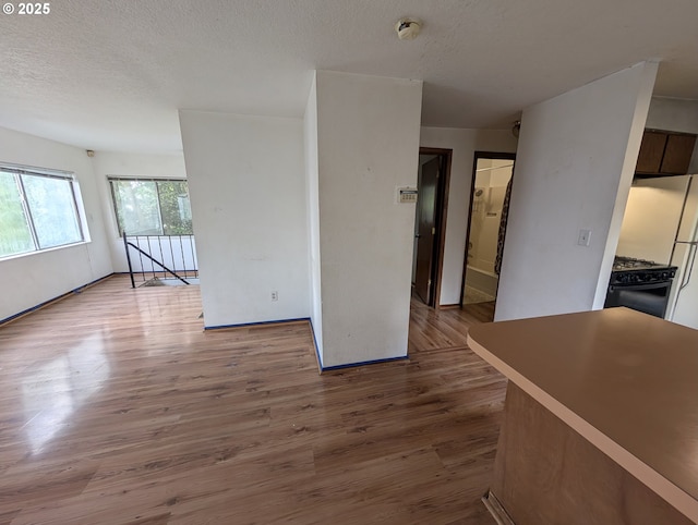 10539 NW 3rd St, Portland, OR 97231 - unfurnished living room featuring wood finished floors and a textured ceiling
