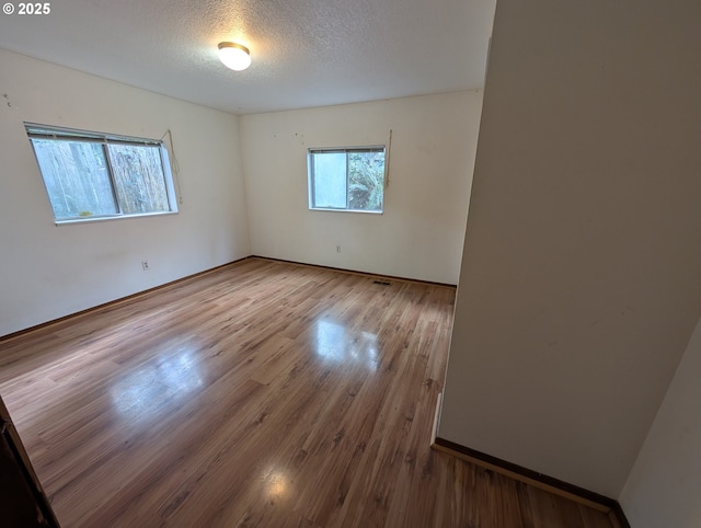 10539 NW 3rd St, Portland, OR 97231 - unfurnished room featuring wood finished floors and a textured ceiling