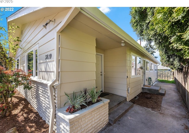 view of side of home featuring fence