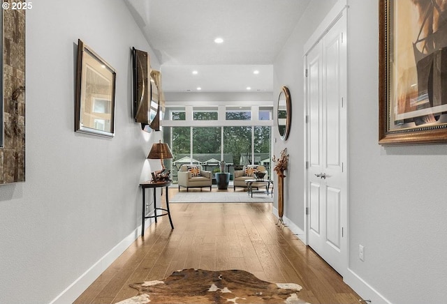 hallway with recessed lighting, baseboards, and wood-type flooring