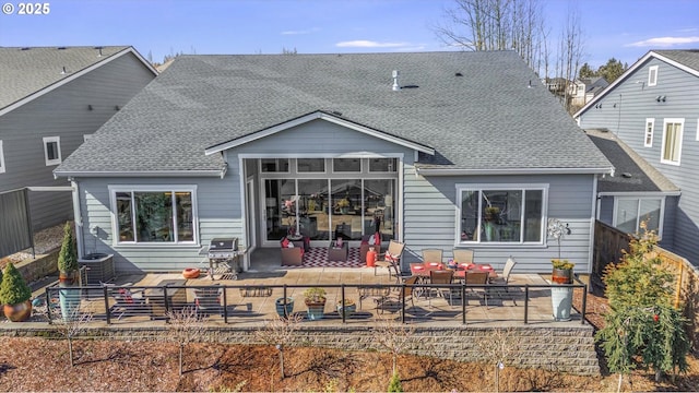 back of property featuring central air condition unit, a patio, roof with shingles, and fence