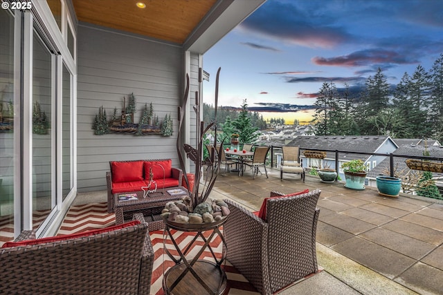 patio terrace at dusk featuring an outdoor living space and outdoor dining area