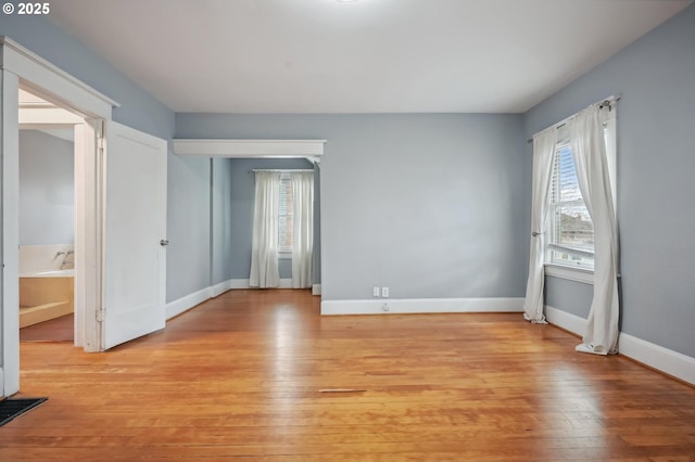 unfurnished bedroom featuring light wood finished floors and baseboards