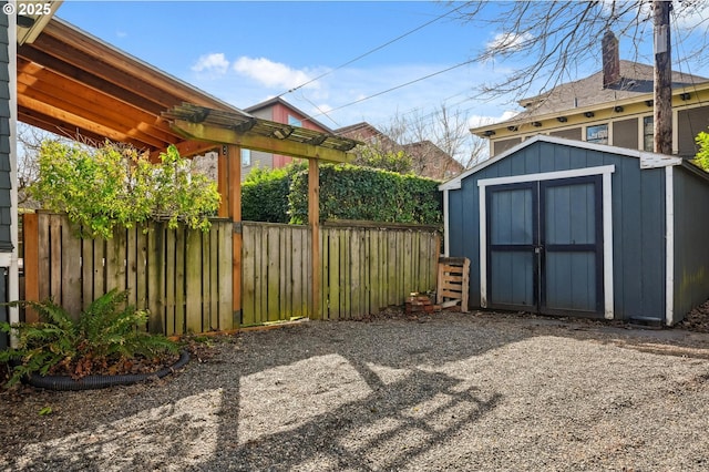 view of shed featuring fence