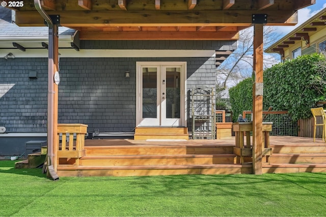 property entrance with a lawn, french doors, and a wooden deck