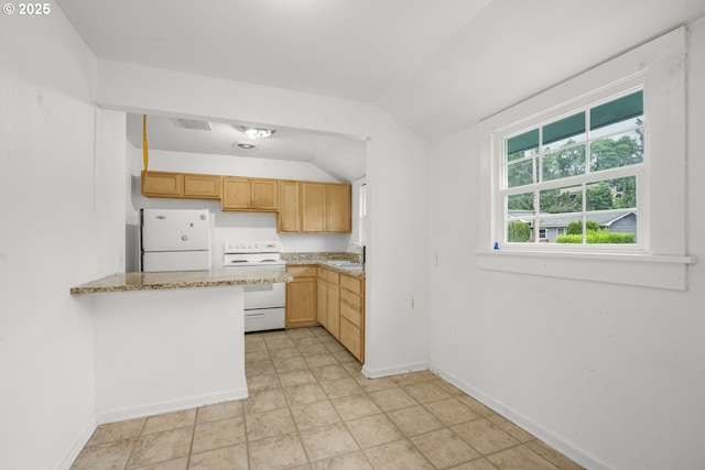 307 Columbia St, Kelso, WA 98626 - kitchen with white appliances, a sink, lofted ceiling, baseboards, and a peninsula