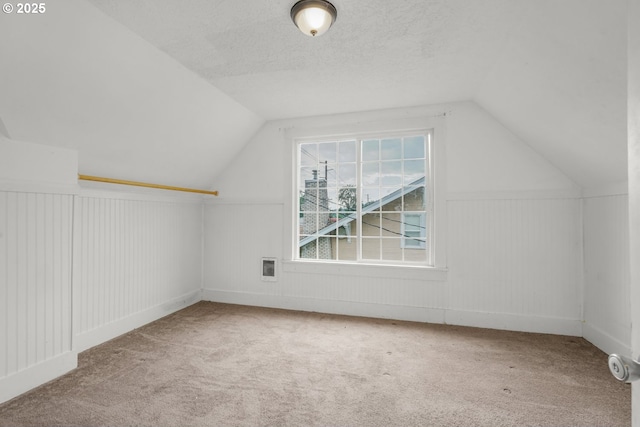 307 Columbia St, Kelso, WA 98626 - additional living space featuring vaulted ceiling, carpet floors, wainscoting, and a textured ceiling