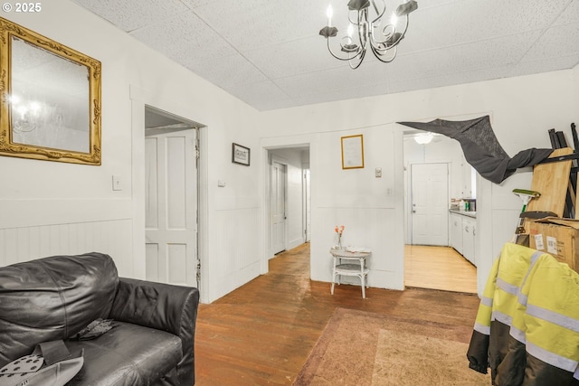 307 Columbia St, Kelso, WA 98626 - living area with wood finished floors, a chandelier, and a wainscoted wall
