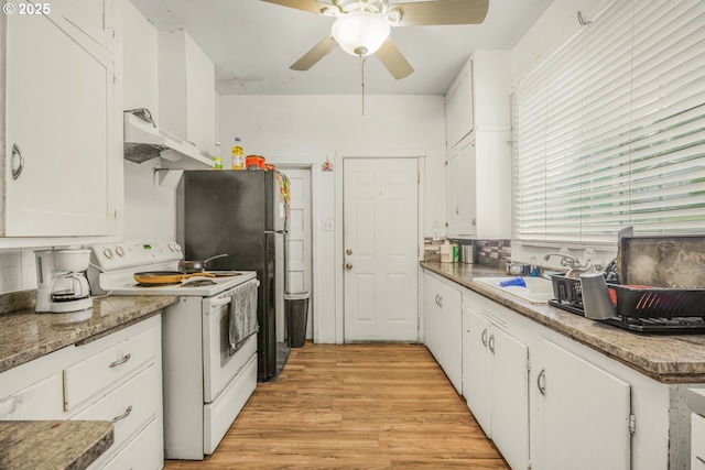 307 Columbia St, Kelso, WA 98626 - kitchen with white electric stove, under cabinet range hood, white cabinetry, a sink, and a ceiling fan