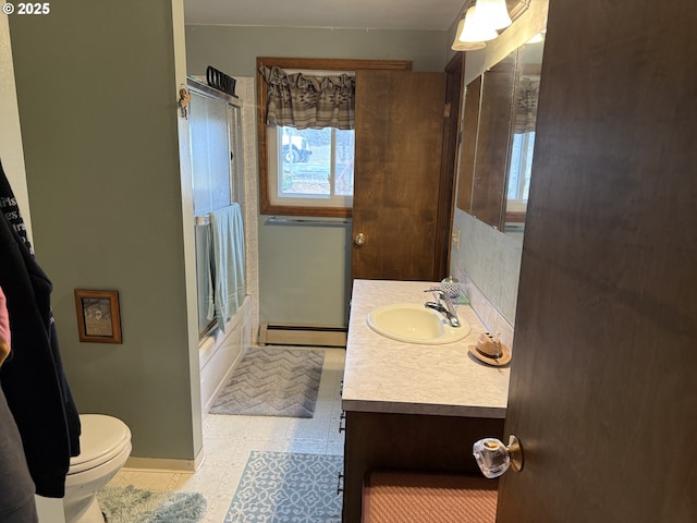 76984 Palmer Junction Rd, Elgin, OR 97827 - bathroom featuring vanity, baseboards, a baseboard heating unit, toilet, and enclosed tub / shower combo