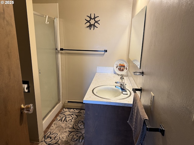 76984 Palmer Junction Rd, Elgin, OR 97827 - full bathroom featuring vanity, baseboards, a baseboard heating unit, and a shower stall