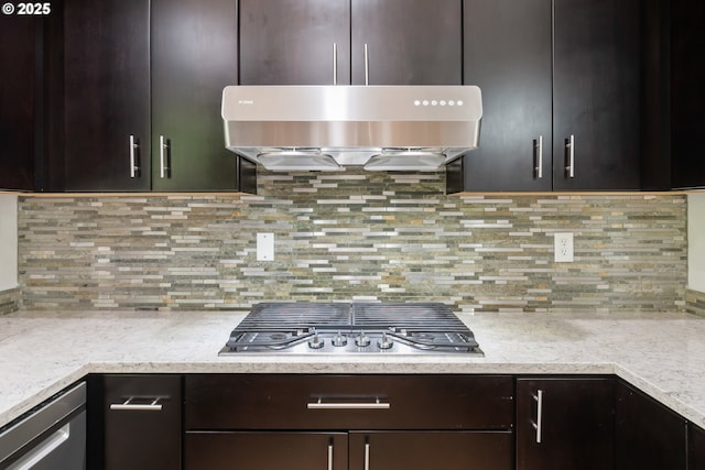 2795 Mallory Ln, Eugene, OR 97401 - kitchen featuring stainless steel gas stovetop, ventilation hood, light countertops, dark brown cabinetry, and backsplash