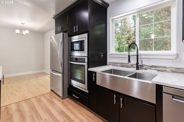 2795 Mallory Ln, Eugene, OR 97401 - kitchen with appliances with stainless steel finishes, a sink, a chandelier, and dark cabinets