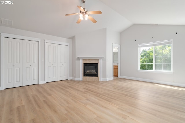 2795 Mallory Ln, Eugene, OR 97401 - unfurnished living room with a ceiling fan, light wood finished floors, baseboards, a tiled fireplace, and high vaulted ceiling