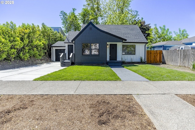view of front of property featuring board and batten siding, a shingled roof, and a garage