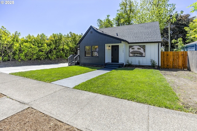 view of front facade featuring board and batten siding and a shingled roof