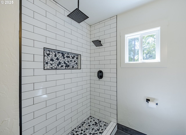 bathroom featuring tiled shower
