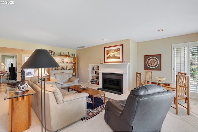 living room with a fireplace with flush hearth, recessed lighting, and baseboards